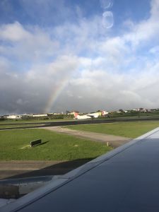 Een regenboog en landend vliegtuig van TAP op Lissabon